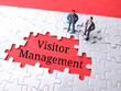 Text Visitor Management written on red background with white puzzle and miniature people.