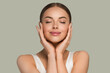 Beauty healthy skin women touching face cosmetic studio portrait. Sportswear color background green