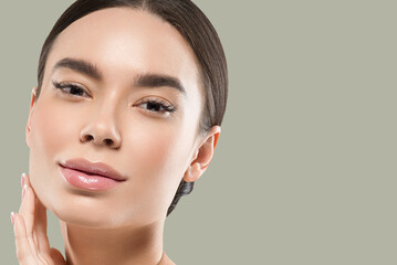 asia woman beauty face body portrait touching her face healthy skin. color background. green