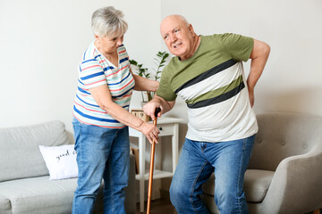 Sticker - Senior woman helping her husband with back pain at home