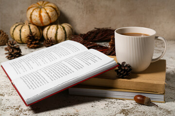 Wall Mural - Cup of tasty coffee and books on light background