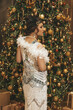 Beautiful woman close up on the decorated fir-tree background. Gatsby style
