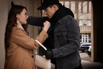 Canvas Print - Woman fighting with thief while he trying to steal her bag in alley. Self defense concept