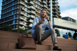 © JustLife - Businessman using the phone while sitting on the stairs. Happy man using the phone