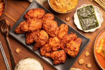 Wall Mural - Traditional Korean food, Korean Fried chicken with spicy sauce  with rice, seaweed and Kimchi pickle on wooden table.