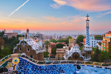 Barcelona City View From Guell Park. Sunrise View Of Colorful Mosaic Building In Park Guell