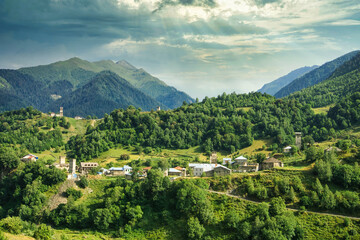 Wall Mural - Ushguli village with rock tower houses in Svaneti, Georgia with a view of Greater Caucasus mountains. These are typical Svaneti defensive tower houses found throughout the village