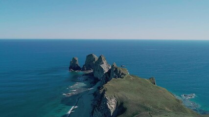 Wall Mural - Aerial panoramic view of cliffs and huge rocks at seaside and waves crashing to the coast. Beautiful seascape.