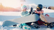 Smiling couple woman and man with snowboards background snowy mountain ski resort, sunny day sunlight. Concept travel winter sports