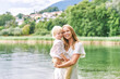 © annanahabed - Outdoor portrait of happy young mother with adorable preschooler son, enjoying nice day next to lake