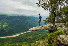 A Man Standing On The Overhanging Leopard Rock Enjoying The Oribi Gorge View In Port Shepstone