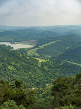 The Majestic Oribi Gorge, Lake And A Female On Zipline Over The Gorge In Port Shepstone South Africa