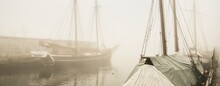 Elegant And Modern Yachts, Sailing And Fishing Boats Moored Ti A Pier In A Fog. Schooner Close-up. Landmarks, Sightseeing, Old Harbor, History, Past. Sepia Image Effect. Germaniahafen, Kiel, Germany