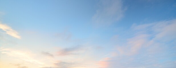 Wall Mural - Clear blue sky with glowing pink and golden clouds after the storm. Dramatic sunset cloudscape. Concept art, meteorology, heaven, hope, peace. Graphic resources, picturesque panoramic scenery