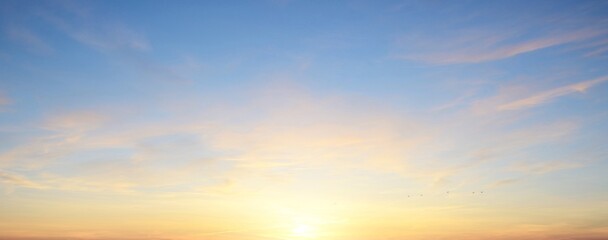 Clear blue sky. glowing pink and golden cirrus and cumulus clouds after storm, soft sunlight. Dramatic sunset cloudscape. Meteorology, heaven, peace, graphic resources, picturesque panoramic scenery