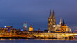 Illuminated historical buildings against Cologne winter skyline