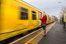Woman On Her Phone As Train Approaches In Liverpool England
