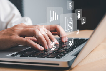 Enterprise Resource Planning ERP, document management concept with icons on virtual screen, Business woman working with laptop computer with icons on virtual screen on office desk.