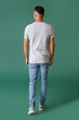 © Pixel-Shot - Handsome young man in stylish t-shirt on color background, back view