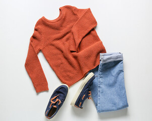 Wall Mural - Children's sweater, jeans and shoes on white background