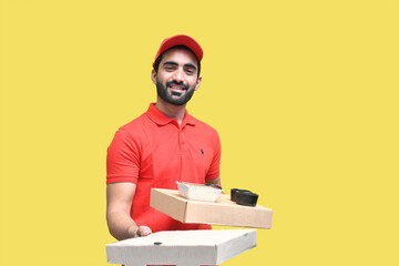 delivery man smiling in red t shirt and cap holding 2 pizza box indian pakistani model