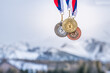 Gold, silver and bronze medal with winter nature in background. Sport trophy concept photo for winter game in China