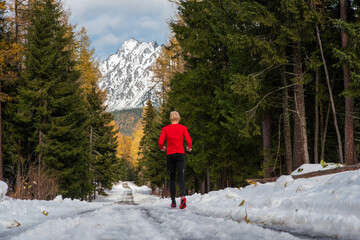 Wall Mural - Trail runner in white winter nature. Active life in winter, sport photo, white edit space