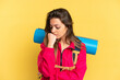 © luismolinero - Young mountaineer man with a big backpack isolated on yellow background having doubts