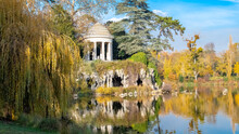 Vincennes, The Temple Of Love And Artificial Grotto On The Daumesnil Lake, In The Public Park, In Autumn
