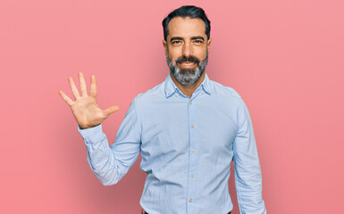 Sticker - Middle aged man with beard wearing business shirt showing and pointing up with fingers number five while smiling confident and happy.