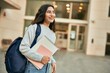 © Krakenimages.com - Young middle east student girl smiling happy holding book at the city.