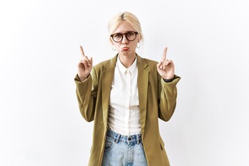 Sticker - Beautiful caucasian business woman standing over isolated background pointing up looking sad and upset, indicating direction with fingers, unhappy and depressed.