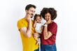 © Krakenimages.com - Interracial young family of black mother and hispanic father with daughter touching mouth with hand with painful expression because of toothache or dental illness on teeth. dentist concept.