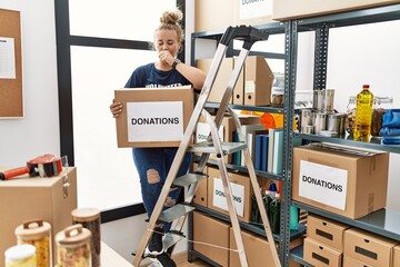 Poster - Young caucasian woman volunteer holding donations box feeling unwell and coughing as symptom for cold or bronchitis. health care concept.