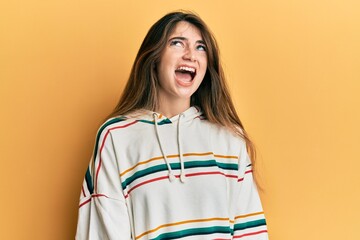 Canvas Print - Young caucasian woman wearing casual clothes angry and mad screaming frustrated and furious, shouting with anger. rage and aggressive concept.