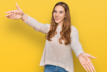 Canvas Print - Young blonde woman wearing casual clothes looking at the camera smiling with open arms for hug. cheerful expression embracing happiness.