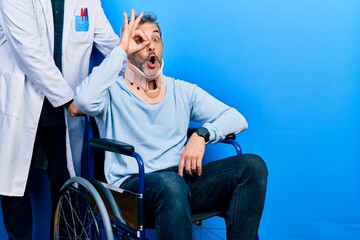 Sticker - Handsome middle age man with grey hair on wheelchair wearing cervical collar doing ok gesture shocked with surprised face, eye looking through fingers. unbelieving expression.