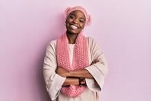 Young African American Woman Wearing Wool Hat And Winter Scarf Happy Face Smiling With Crossed Arms Looking At The Camera. Positive Person.