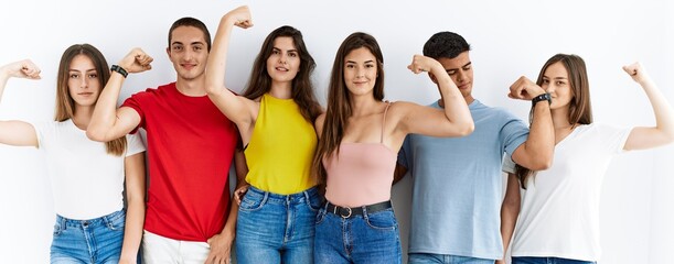 Poster - Group of people wearing casual clothes standing over isolated background strong person showing arm muscle, confident and proud of power