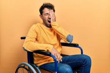 Sticker - Handsome man with beard sitting on wheelchair yawning tired covering half face, eye and mouth with hand. face hurts in pain.