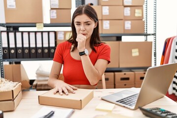 Wall Mural - Young hispanic woman preparing order working at storehouse feeling unwell and coughing as symptom for cold or bronchitis. health care concept.