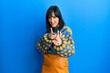© Krakenimages.com - Young hispanic woman wearing casual winter sweater pointing fingers to camera with happy and funny face. good energy and vibes.