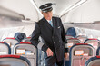 © Kostiantyn - Man airline captain standing in passenger airplane cabin