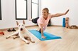 © Krakenimages.com - Young caucasian woman smiling confident stretching with dog at sport center