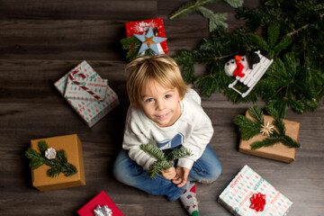 Canvas Print - Cute child, lying on the floor with many presents