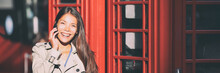 Phone Call Woman Talking On London City Walk With Telephone Booths In Background. Panoramic Banner Of Asian Businesswoman Using Mobile 5g Technology.
