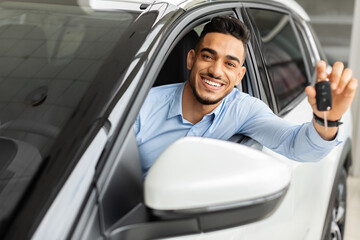 Wall Mural - Happy arab man holding key from auto, buying car