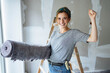 Elated young woman renovating her new home