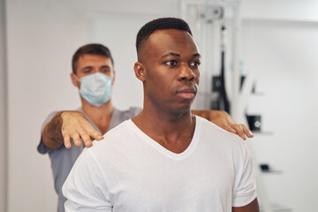 Wall Mural - Tranquil young male patient undergoing spine examination