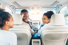 Happy Black Family Of Three Enjoying Car Ride During Summer